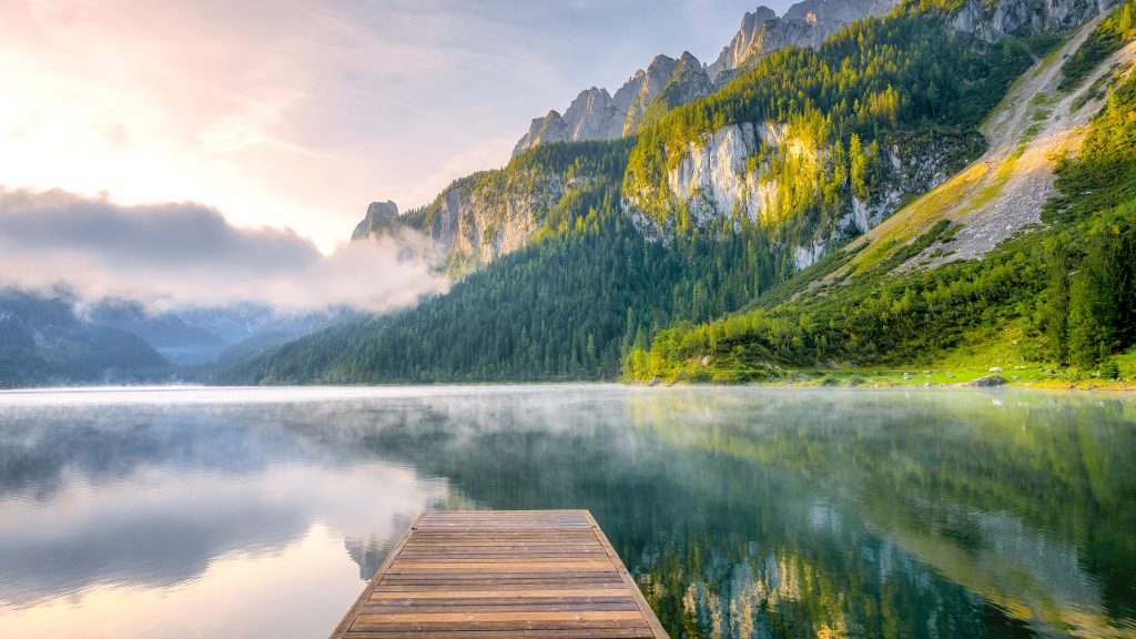 Sunrise with fog over alpine lake Vorderer Gosausee, Gosau valley in Upper Austria