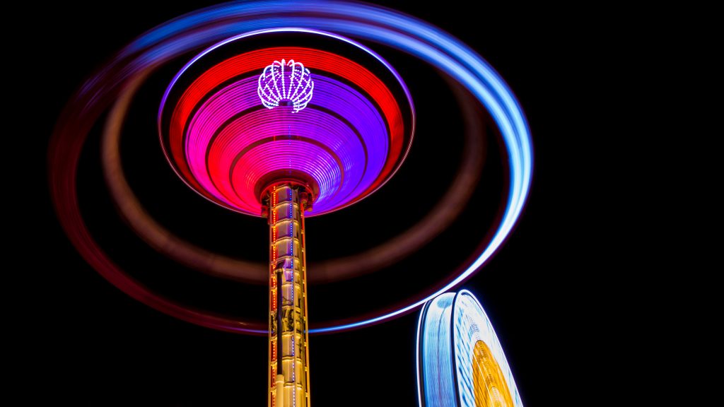 Colorful glowing spinning carnival ride, Tuileries Garden, Paris, France