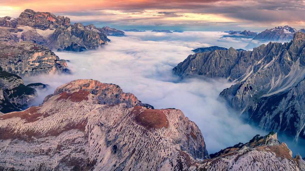 Foggy autumn aerial view of mountains valley in Tre Cime Di Lavaredo National Park, Italy