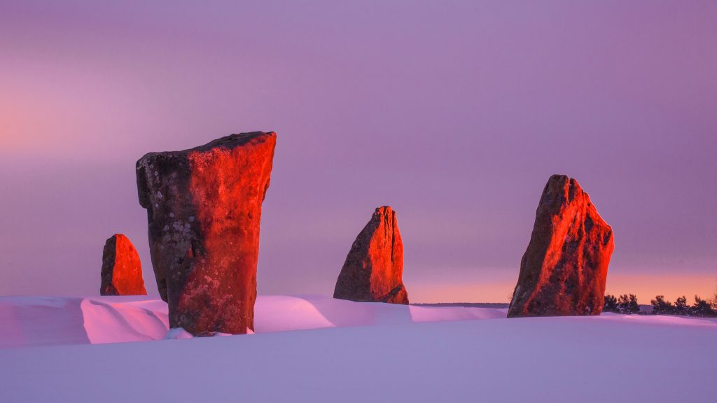 Red winter dawn at Nine Stones Close, Derbyshire, England, UK