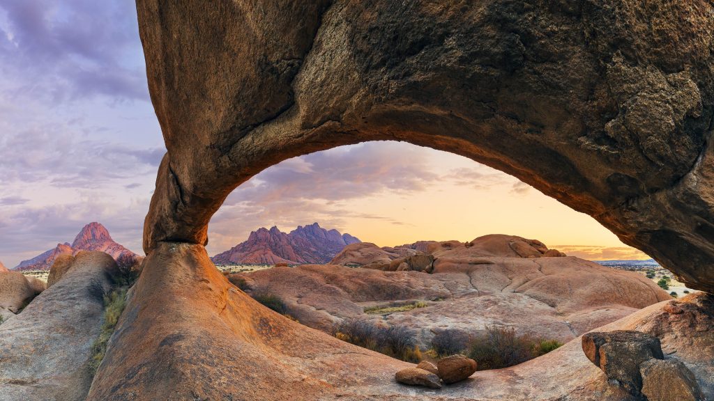 Sunrise at Eye of Spitzkoppe archway rock formation, Namibia