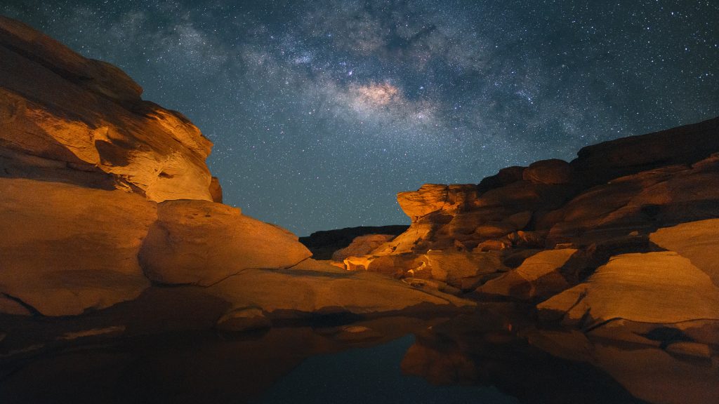 Milky way above rock field at Sam Pan Bok during night, Thailand