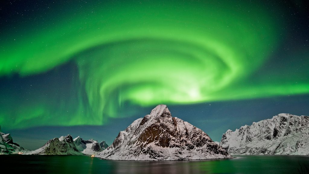Aurora borealis over steep mountains of Moskenesøya Island, Lofoten, Norway
