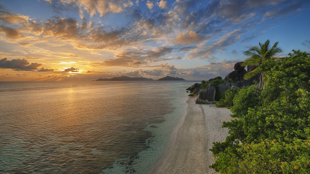 Anse Source d' Argent beach with rocks and trees at sunset, La Digue, Seychelles