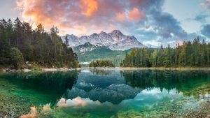 Read more about the article Mountain peak Zugspitze reflected in Eibsee lake on a summer day, Bavaria, Germany