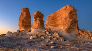 Read more about the article Rock towers at dusk in El Agabat area in White Desert National Park, Egypt