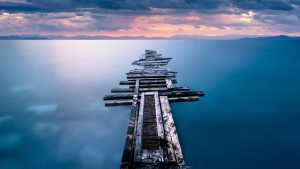 Read more about the article Old wooden pier at sunset in Corinthia, Greece