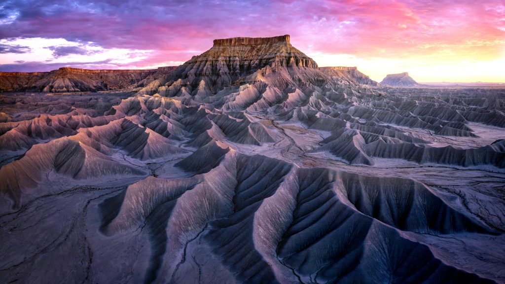 Factory Butte Recreation Area aerial view in Utah desert valley at sunset, USA