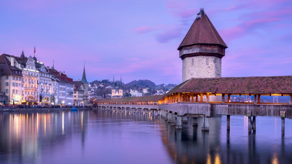 Kapellbrücke covered wooden footbridge on river Reuss at sunset, Lucerne, Switzerland