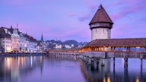 Read more about the article Kapellbrücke covered wooden footbridge on river Reuss at sunset, Lucerne, Switzerland