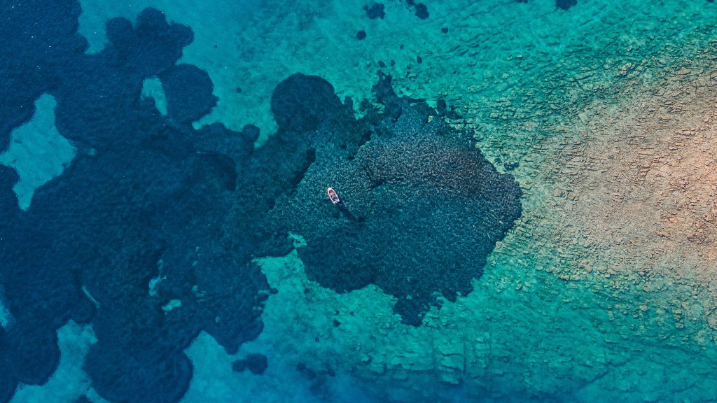 Boat floating on the Mediterranean Sea above a reef, Crete, Greece