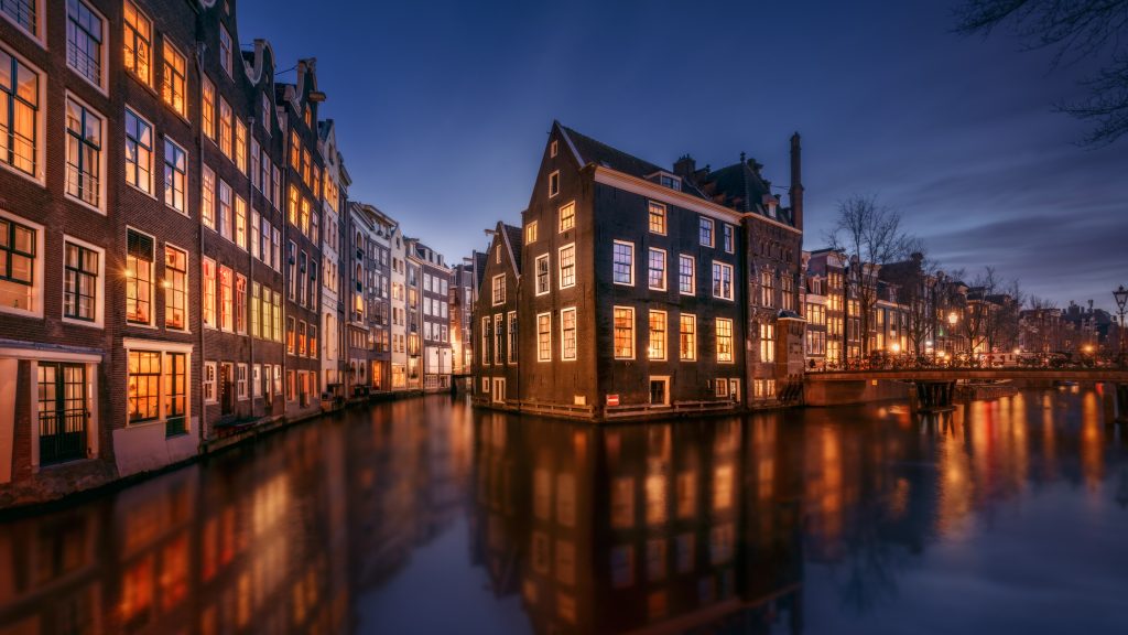 Tranquil canal scene with houses by night, Amsterdam, Netherlands